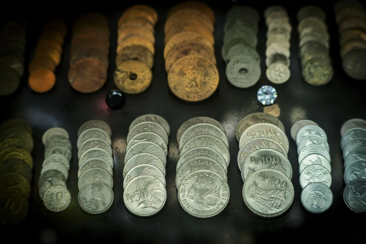 A collection of antique Indonesian coins displayed, highlighting the historical significance of currency.